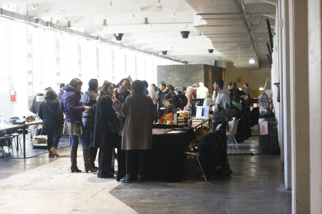 People around a stand talking