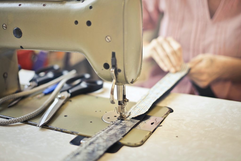 Sewing machine and woman working on it